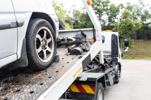 The Ultimate Guide to Fuel Efficiency for Sydney Roads cable attached to broken down car being pulled onto tow truck